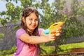Determined girl in fun water gun fight game Royalty Free Stock Photo