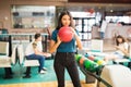 Determined Girl Getting Ready To Throw Bowling Ball At Alley