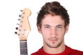 Determined man holding a guitar Royalty Free Stock Photo