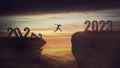 Determined man jump over a chasm obstacle to reach the new 2023 peak and let 2022 behind. Conceptual and surreal sunset scene, new