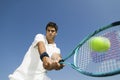 Determined Man Playing Tennis Against Sky