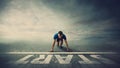 Determined man runner standing in running position, at the start line, looking ahead confident. Young guy sprinter ready for new Royalty Free Stock Photo