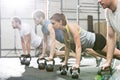 Determined people doing pushups with kettlebells at crossfit gym Royalty Free Stock Photo