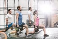 Determined people lifting kettlebells at crossfit gym