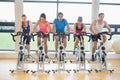 Determined people working out at spinning class in gym