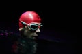 A determined professional triathlete undergoes rigorous night time training in cold waters, showcasing dedication and