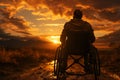 Determined silhouette wheelchair user against sunset, illustrating strength and overcoming obstacles