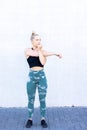 Determined, strong and healthy sports woman, stretching, stretch her arms, warm up for workout in gym, looking away