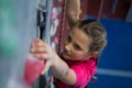 Determined teenage girl practicing rock climbing