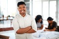 Determined to design the best. Portrait of a confident young businessman standing in front of a team of architects. Royalty Free Stock Photo