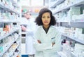 Determined to do whats best for your wellness. Portrait of a confident young woman working in a pharmacy with her