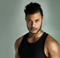 Determined to reach his fitness goals. Studio portrait of an athletic young man posing against a gray background.