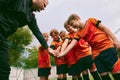 Determined to win. Junior soccer team stacking hands before a match, outdoors. Concept of sport, competition, studying Royalty Free Stock Photo