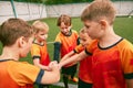 Determined to win. Junior soccer team stacking hands before a match, outdoors. Concept of sport, competition, studying Royalty Free Stock Photo