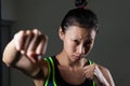 Determined woman practicing boxing in fitness studio