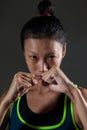 Determined woman practicing boxing in fitness studio