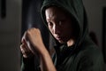 Determined woman practicing boxing in fitness studio