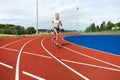 Determined Woman Running On Sports Tracks