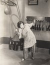 Determined woman in silk pajamas lifting weights in gym Royalty Free Stock Photo