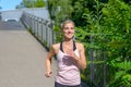 Determined woman smiling happy while jogging Royalty Free Stock Photo