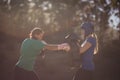 Determined women practicing boxing during obstacle course