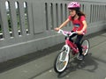 Determined young girl rides a bike