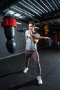 Determined young sportsman performing standing Deltoid Stretch