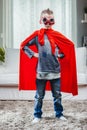 Determined young Super Hero in a colorful red cape Royalty Free Stock Photo