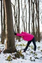 Determined young woman stretching after a workout on cold winter day. Active and healthy lifestyle concept Royalty Free Stock Photo