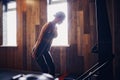 Determined young woman working out on row machine in fitness stu Royalty Free Stock Photo