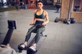 Determined young woman working out on row machine in fitness stu Royalty Free Stock Photo