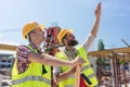 Determined young worker pointing up while imagining the height of a building