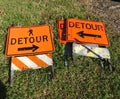 Detour signs lying in grass Royalty Free Stock Photo