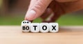 Detox instead of Botox. Hand turns a dice and changes the expression Royalty Free Stock Photo