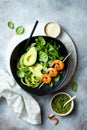 Detox Buddha bowl with avocado, spinach, greens, zucchini noodles, grilled shrimps and pesto sauce. Royalty Free Stock Photo