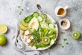 Detox Buddha bowl with quinoa, avocado, zucchini noodles, tofu, spinach, micro greens, pepitas.