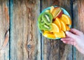 Detox concept. Plate with fruits on a picturesque wooden table.