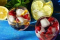 Detox cool drink with ice cubes and fresh raspberries, blueberries and fresh lemon