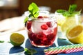 Detox cool drink with ice cubes and fresh raspberries, blueberries and fresh lemon