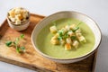 Detox cream soup of green vegetables broccoli, green peas, spinach served with crutons and micro greens on grey concrete Royalty Free Stock Photo