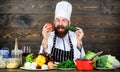 Detox diet. Professional chef in cook uniform. Happy bearded man cooking in kitchen. Dieting with organic food. Fresh Royalty Free Stock Photo