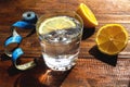 Detox diet and weight loss concept. A glass of water with lemon and a measuring tape, metric rules on a wooden