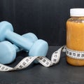 Detox drink with dumbbells and measuring tape. Free space for text. Concept: detox and fitness, diet and exercises Royalty Free Stock Photo