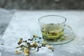 Detox food and drink healfhy lifestyle concept. Glass cup of green tea with jasmine on a gray background. Close