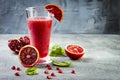 Detox fresh juice or smoothie in glass with blood oranges, greens, pomegranate. Homemade refreshing fruit beverage. Copy space. Royalty Free Stock Photo