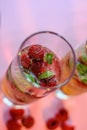 Detox fruit infused water. Refreshing summer homemade cocktail with red raspberries and green leaves in glasses Royalty Free Stock Photo