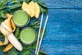 Detox green smoothie with spinach, pineapple, banana and yogurt, flat lay, copy space Royalty Free Stock Photo