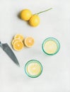 Detox lemon water in glasses and fresh lemons, top view Royalty Free Stock Photo