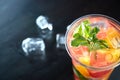 Detox lemonade with grapefruit and orange slices with fresh citrus and ice on a black wooden background. view from above Royalty Free Stock Photo