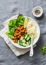 Detox moroccan spiced chickpea glow bowl on a grey background, top view